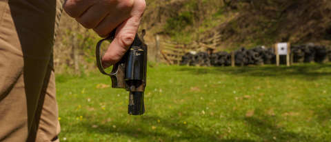 hand holding gun at shooting range