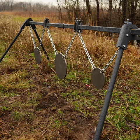 metal gongs aligned at an outdoor shooting range