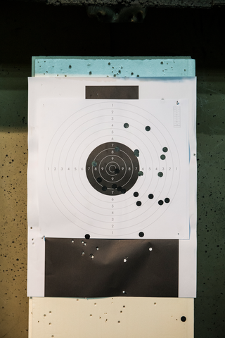 paper shooting target with bullet marks