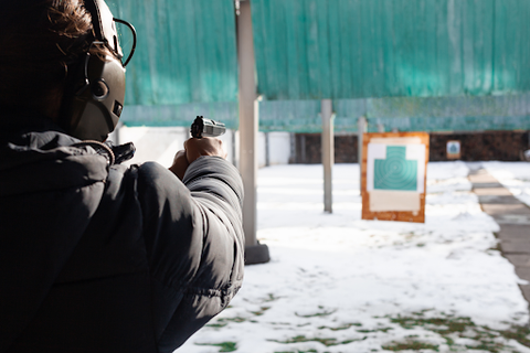 man pointing a gun at a target