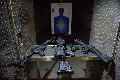 indoor shooting range with guns on table safety