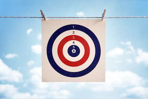 A red, white and blue bulls eye target pegged onto a line