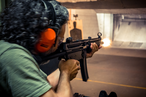 A person dry firing at a shooting range