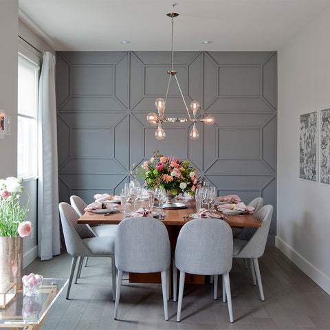 Chic dining room with matte grey feature panel wall in background.