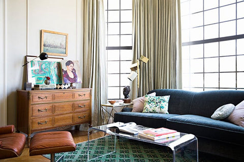 Living room with dark blue sofa, brown Living room with dark blue sofa, brown credenza, brown recliner and glass coffee table