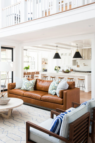 Double storey house with white kitchen and brown sofa