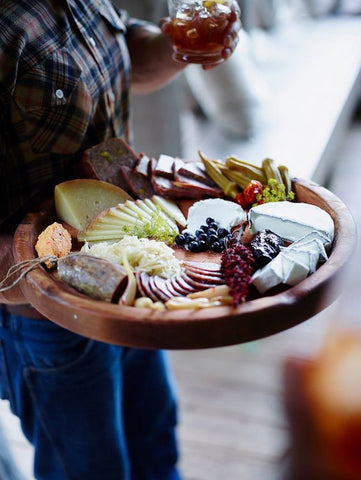 Man holding a Cheese platter