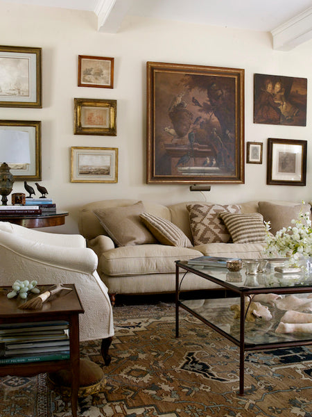 Living room with cream sofa and frames on wall