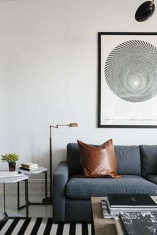 Lounge room with blue fabric sofa and a brown leather cushion