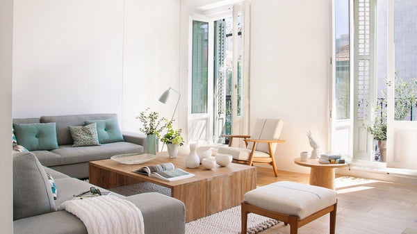 Living room with white walls, grey sofa and wooden coffee table