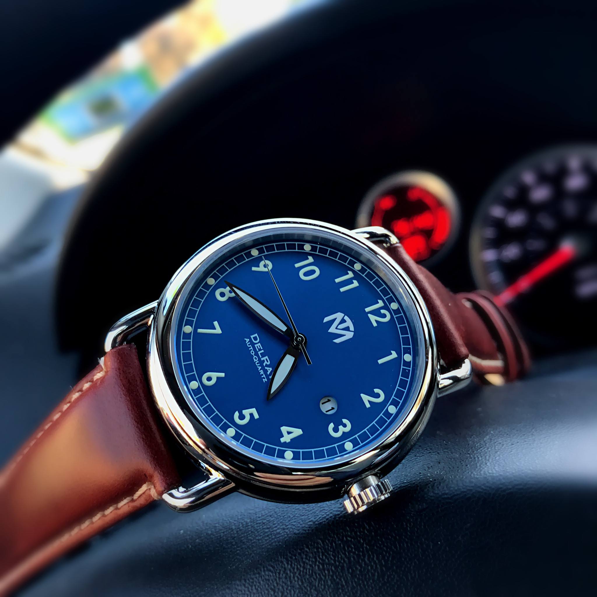 blue face watch with leather strap