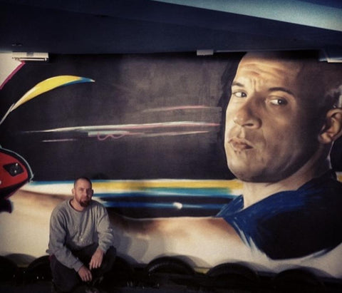 Jaime Kerr with one of his mural designs 