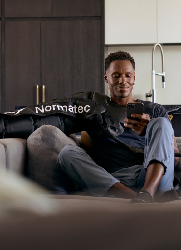 Man using Hyperice NormaTec arm