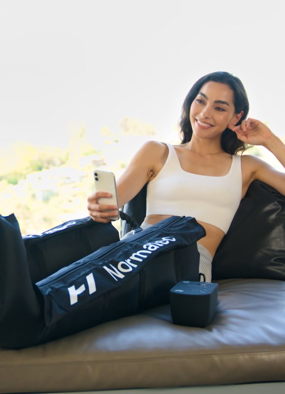 Lady using Hyperice NormaTec legs