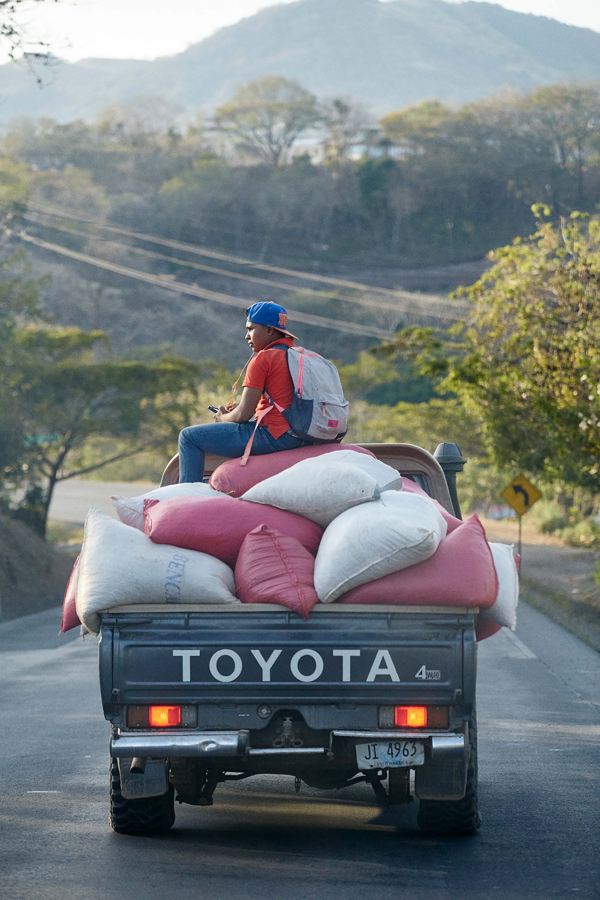 Nicaraguan coffee farmer on truck with coffee sacks