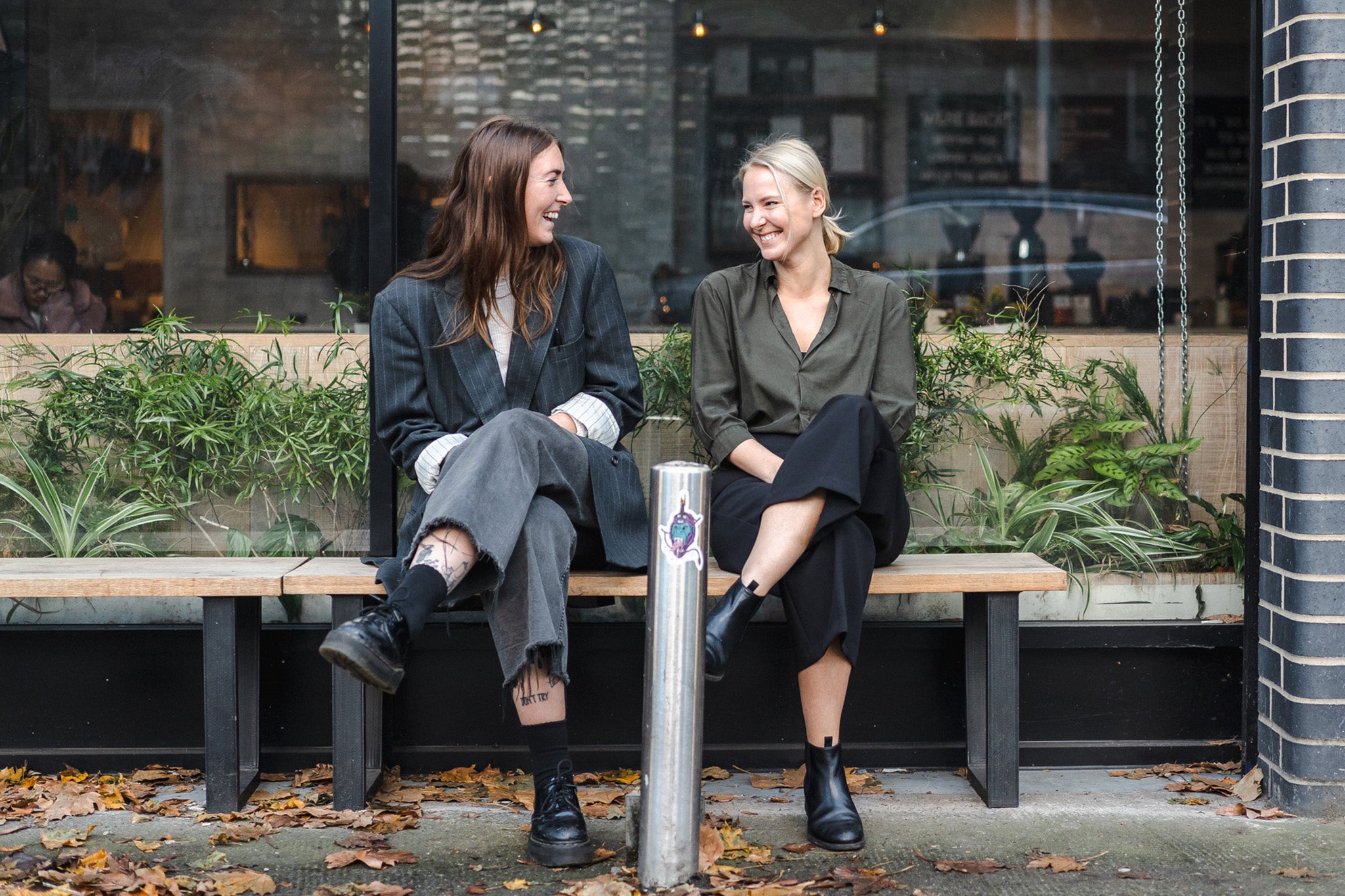 Two friends sitting outside an Origin Coffee shop