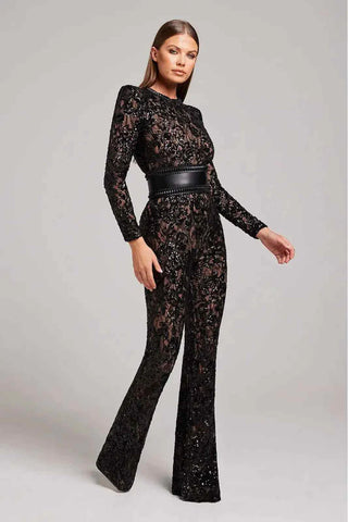 Woman wearing long-sleeved black jumpsuit with embellished lace detailing