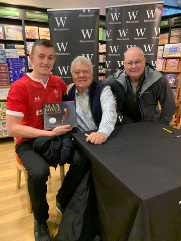 David and Alun Nash sitting with Max Boyce at the book stand. 