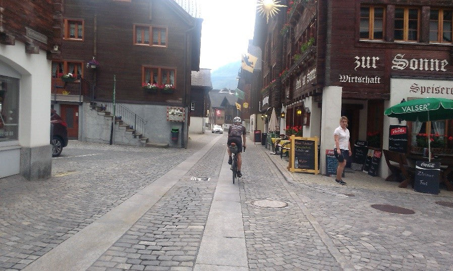 Phil racing over the cobbles of Andermatt, on the scout out for a hotel.