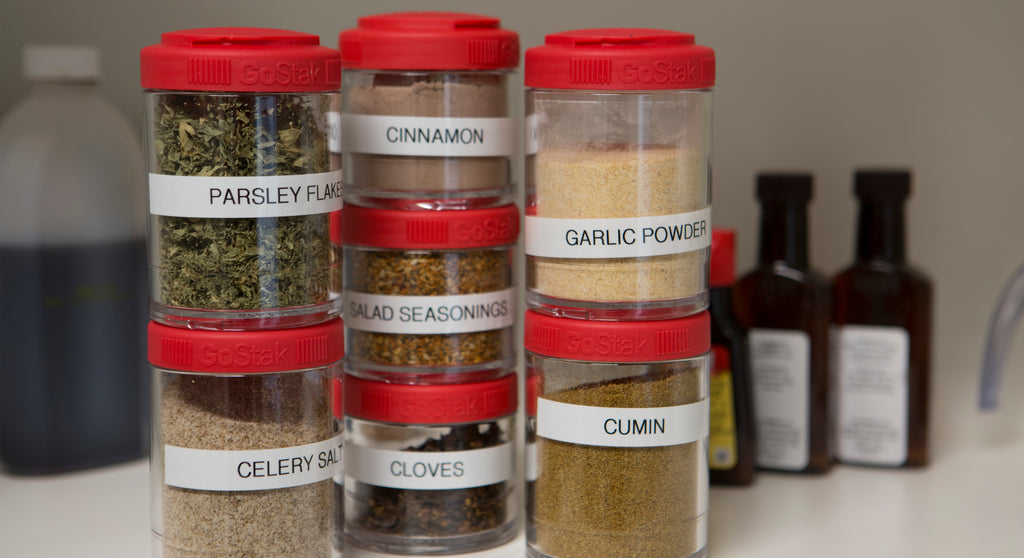 Red GoStak's Used to stack spices on a kitchen countertop