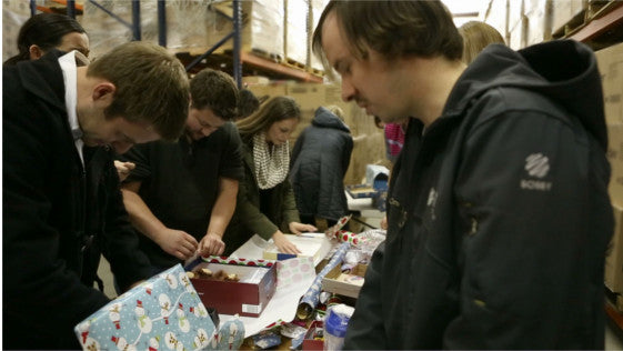 BlenderBottle Employees helping wrap presents