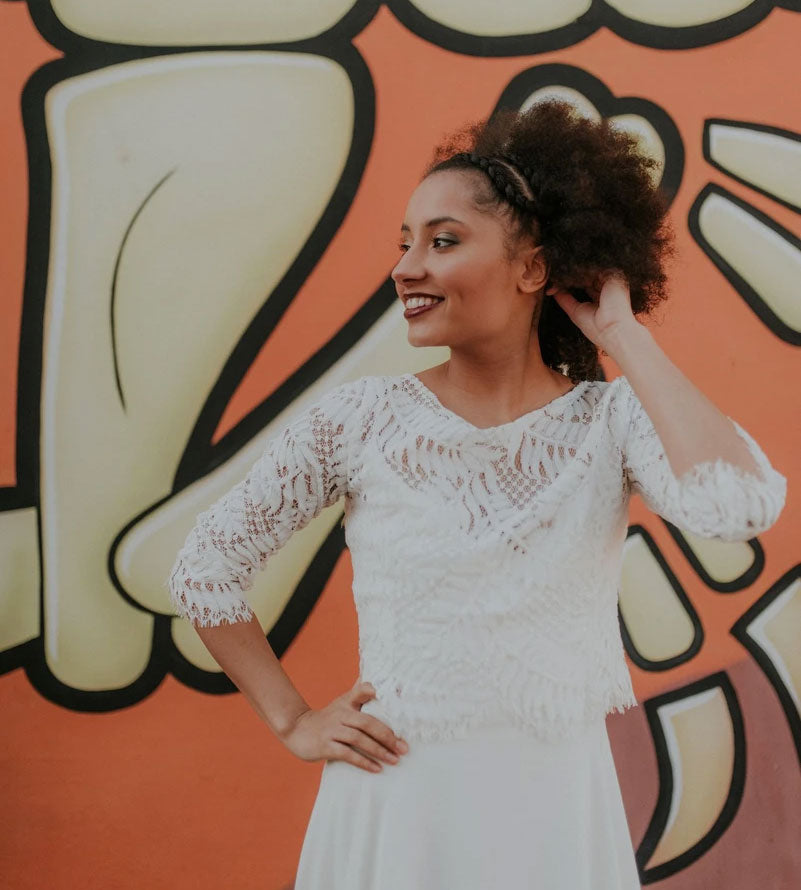 A happy bride showing off her bespoke wedding dress