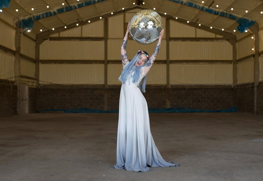 Bride holding a disco ball in an ombre wedding dress