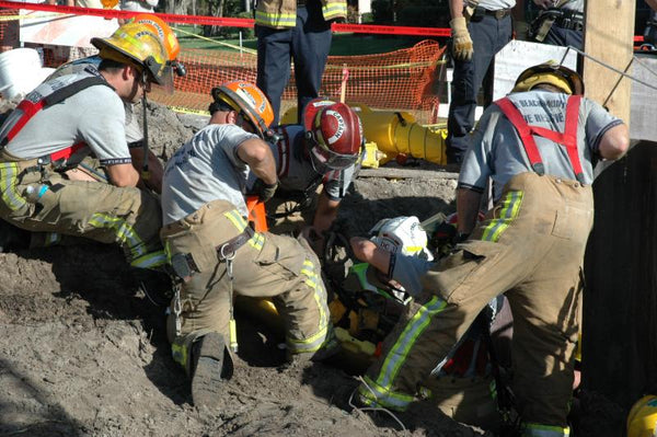 Rescuers saving a construction worker from a trench collapse