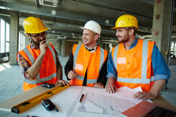 Workers wearing yellow hard hats and a white hard hat