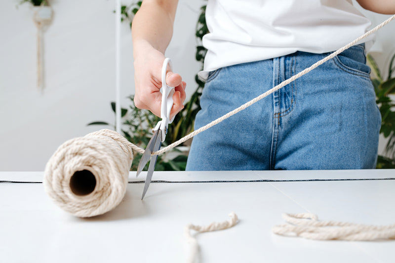 woman cutting macrame cord