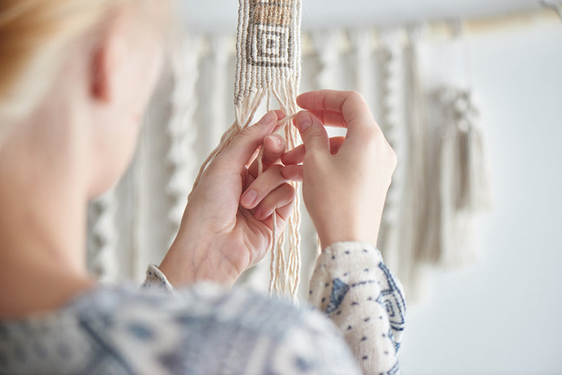 Woman working on macrame projects