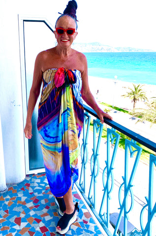 woman wearing colour sarong standing on balcony