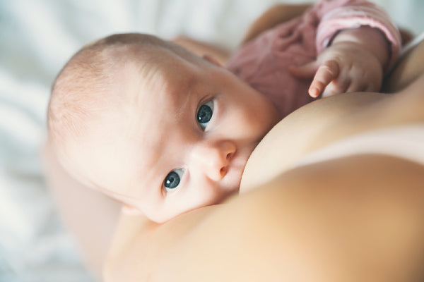 Photo of baby looking up while breastfeeding