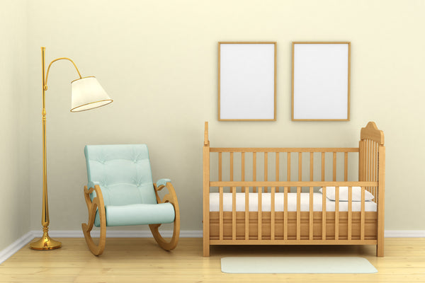 A cot and nursing chair set up in a newly decorated nursery