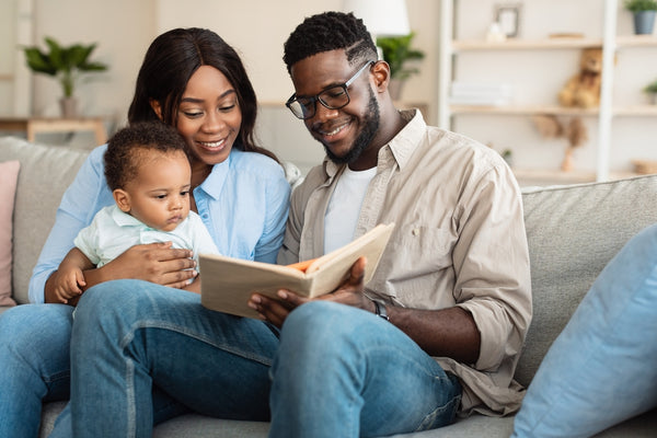 Mother and father reading to their baby