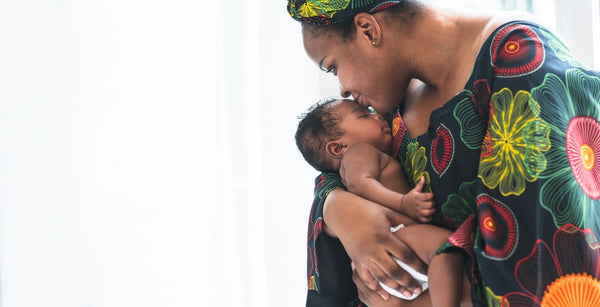 Mother kissing baby