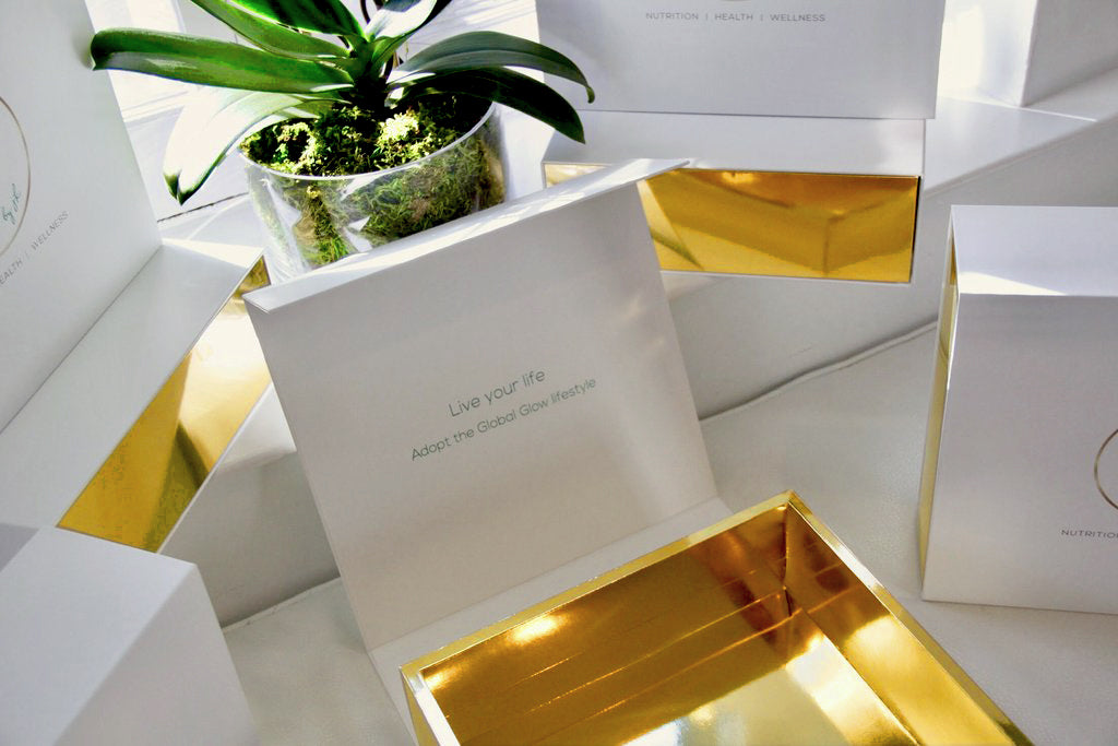 Madovar white outside, gold inside magnetic closure boxes with custom acetate reveal and custom printing for Global Glow products