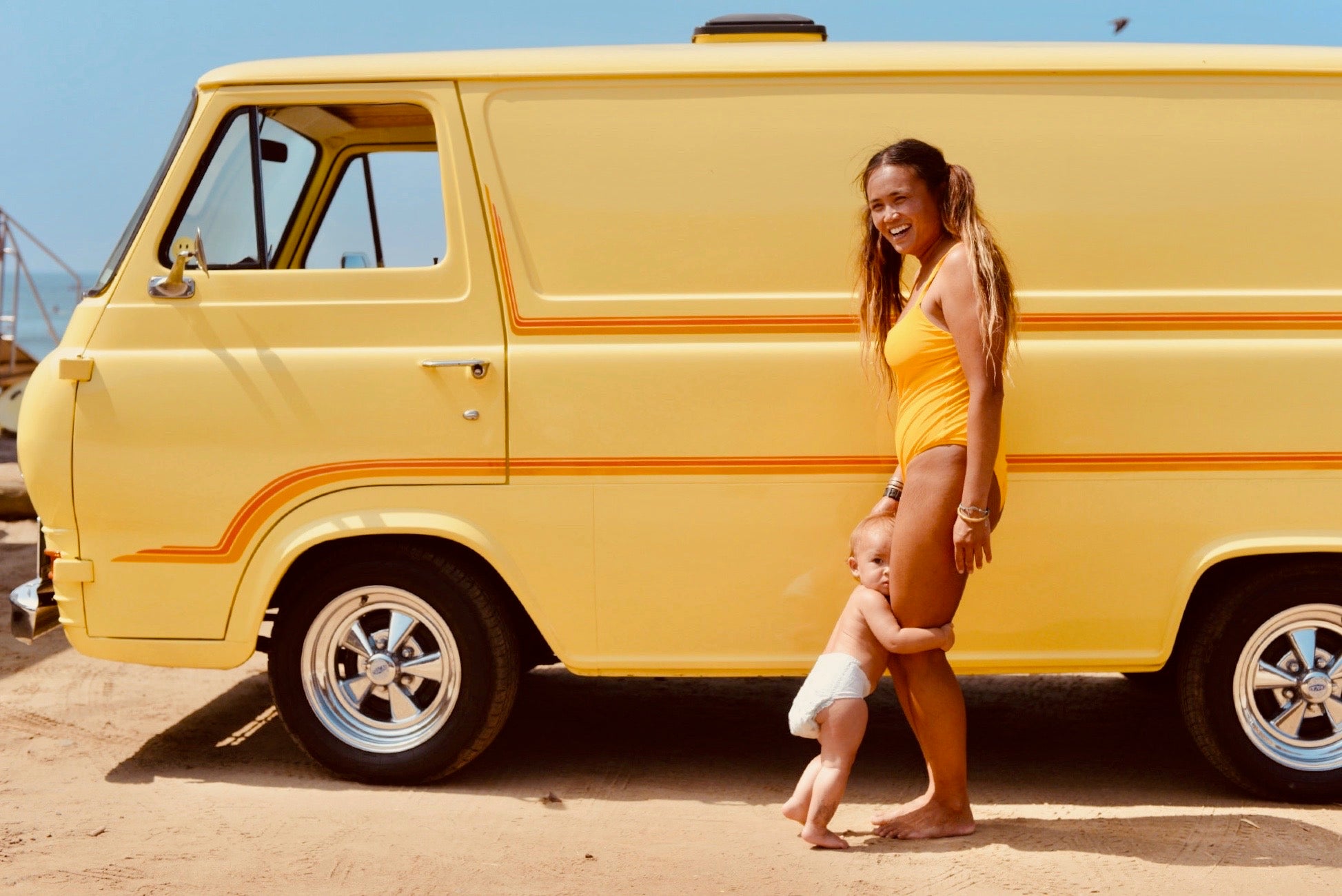 mom and child standing by a van