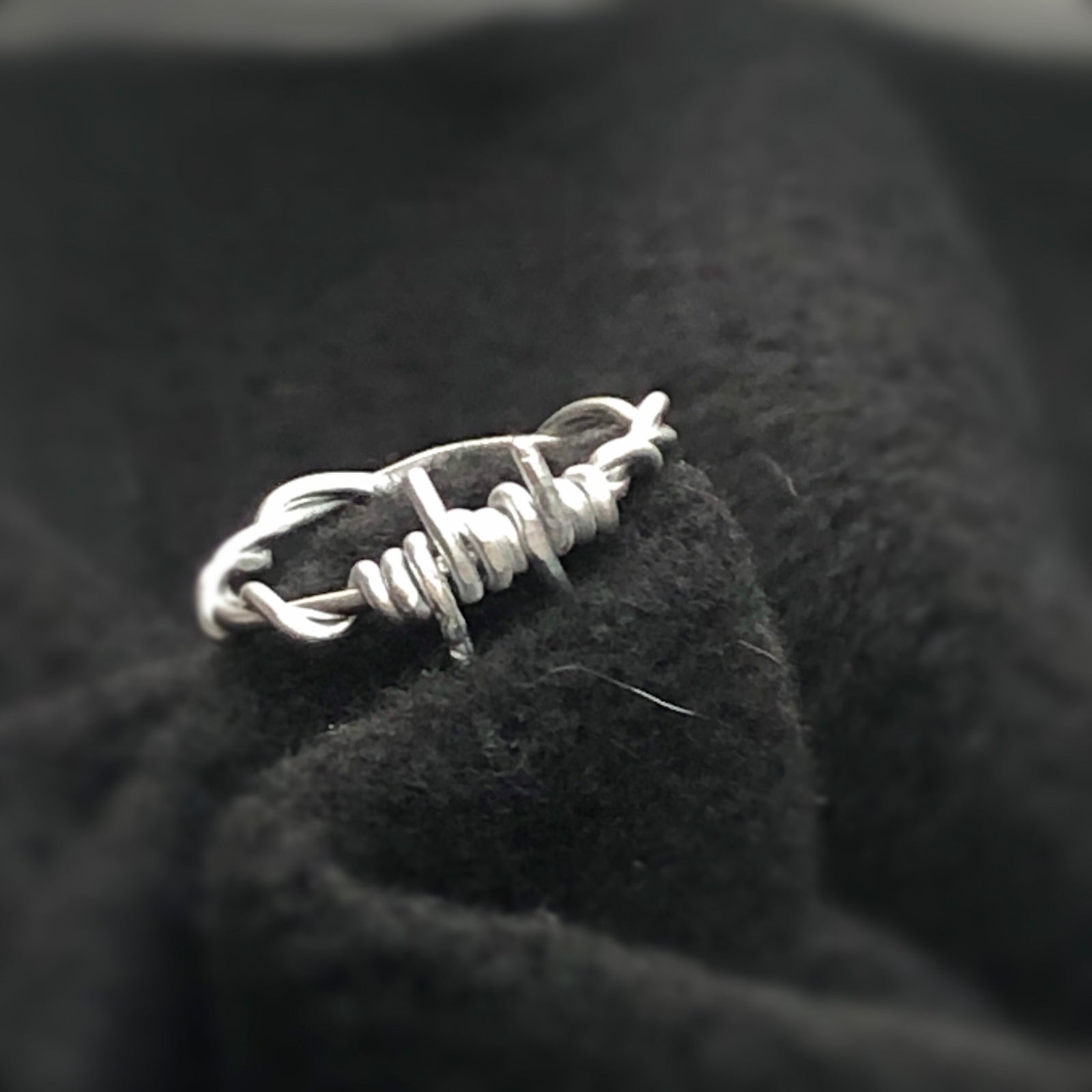 Entangled silver wire ring in a grunge optic