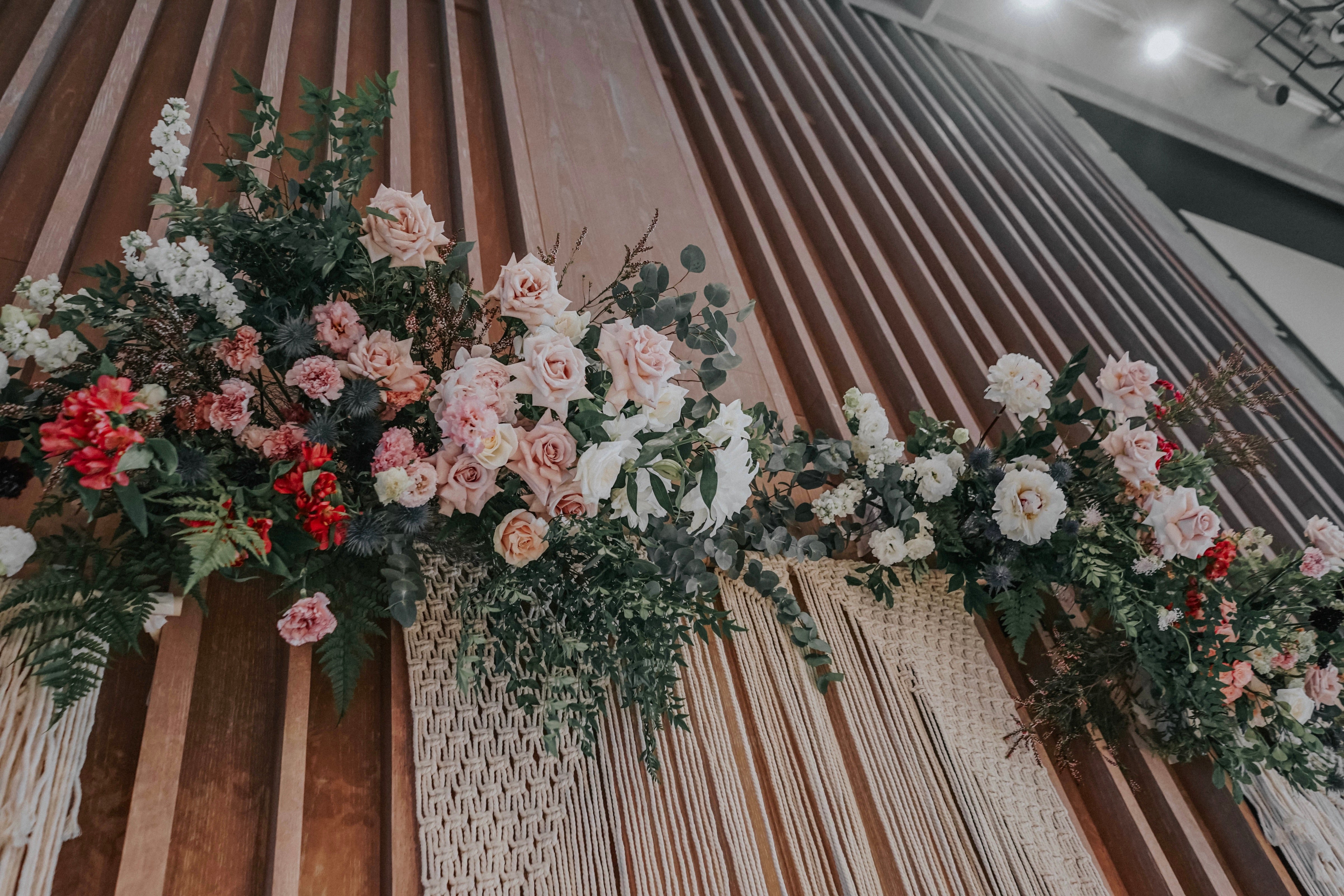 Macrame backdrop with ivory peonies, dusty pink roses in place of wedding feature table at Andaz Singapore Hotel Bugis lunch reception 