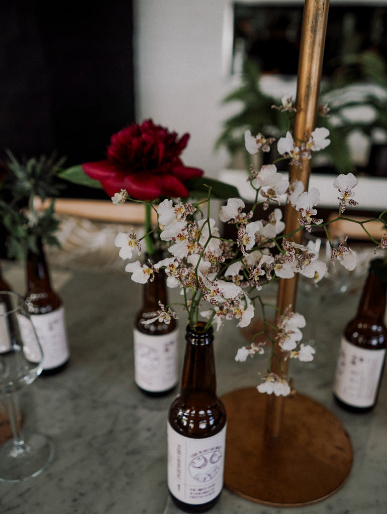 Tropical Elegance Red & Blush Floral Installation for an outdoor wedding at Panamericana Sentosa Singapore. Beer bottle flowers