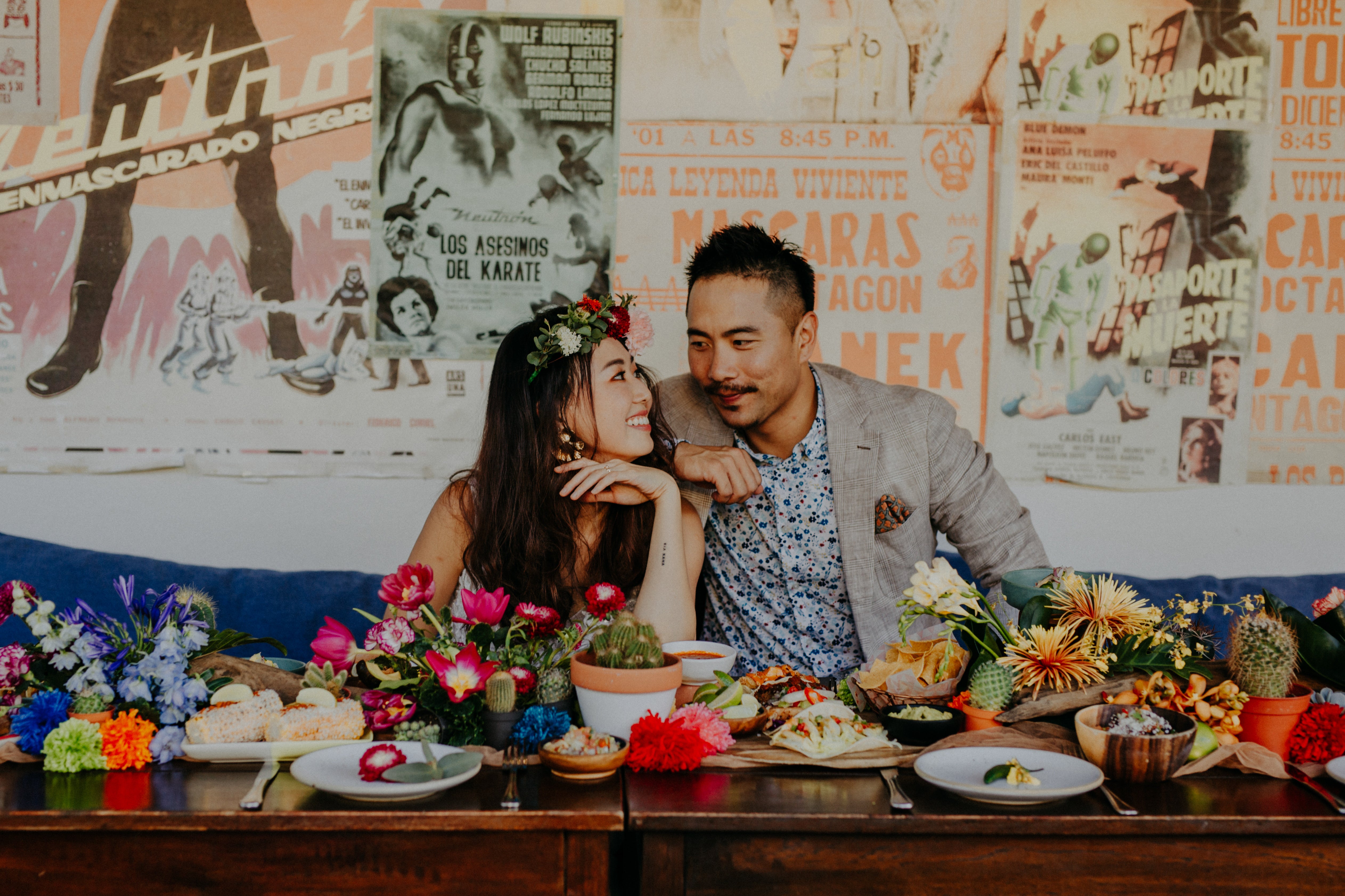 Wedding photo poses couples in front of table set up for casual wedding dinner Mexico theme