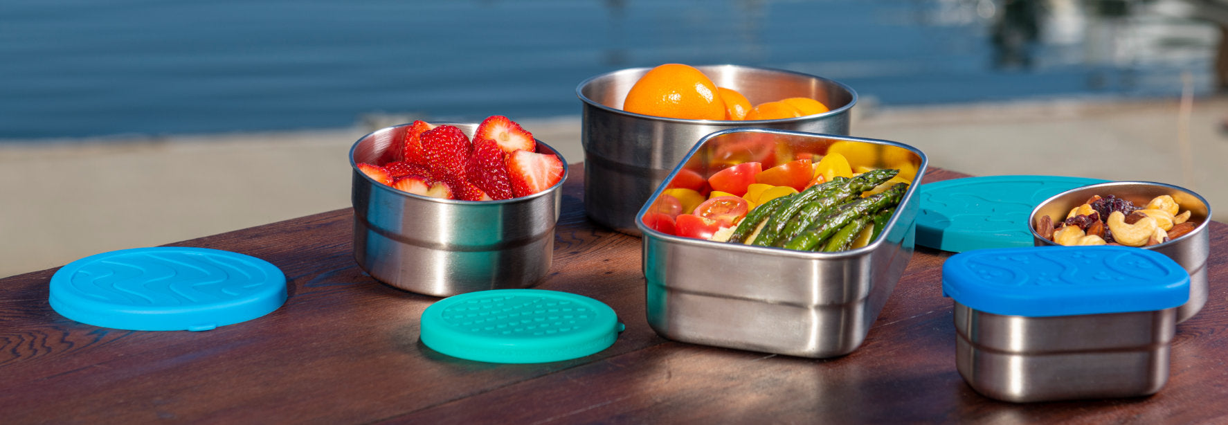 ECOlunchbox stainless steel lunchbox containers on outdoor table at a pier