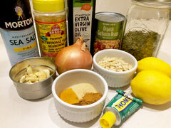 Tali sauce recipe ingredients including salt, garlic, lemon, pumpkin seeds, mustard, onion, blanched almonds, garbanzo beans and spices