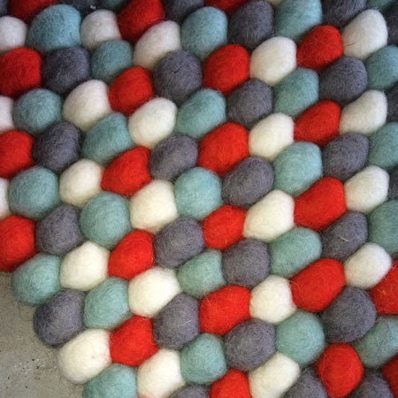 red and grey felt ball rug