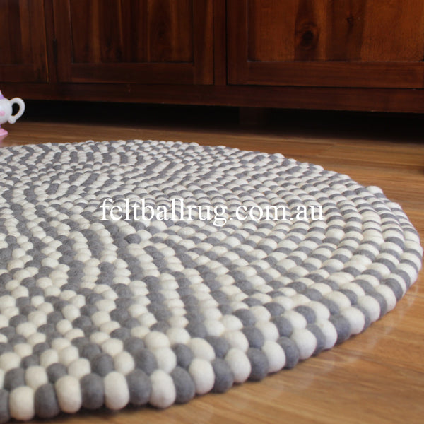 grey and white felt ball rug