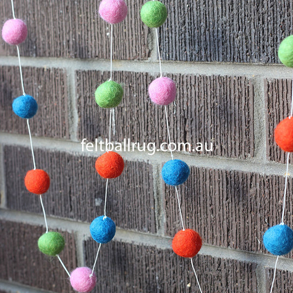 felt ball garland pink red green and blue