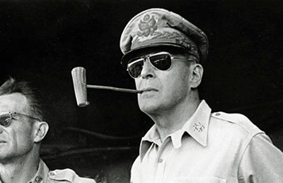 General Douglas MacArthur with aviator style glasses and his signature corncob pipe in the Philippines in 1945.