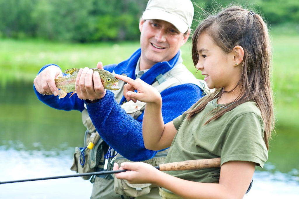 Father and daughter fishing trout