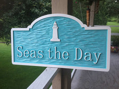 Seas the day sign with lighthouse